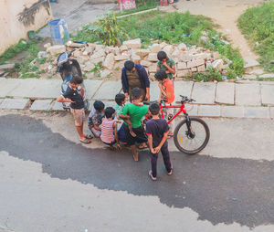 High angle view of people cycling on street