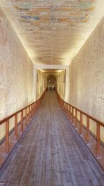 Empty footpath in illuminated building