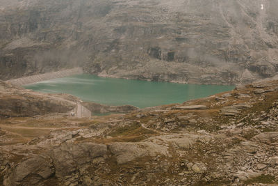 Scenic view of dam by mountains