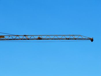 Low angle view of bridge against clear blue sky