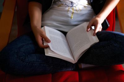 Low section of woman sitting on bench