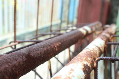 Close-up of rusty metal fence against blurred background