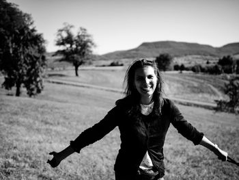 Portrait of smiling girl standing on field
