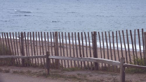 Chairs on beach against sky