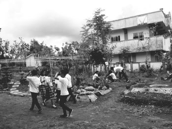 People in front of built structure against sky