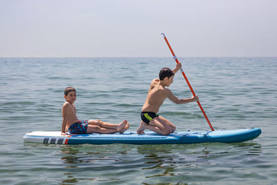 Rear view of man swimming in sea