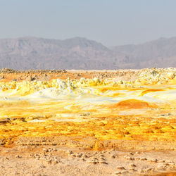 Scenic view of arid landscape against sky