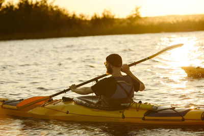 Man kayaking on sunny autumn day