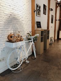 Bicycle on table against wall in building