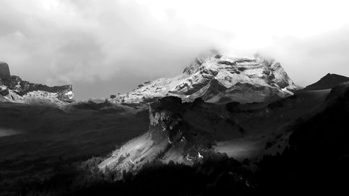 Scenic view of snow mountains against sky