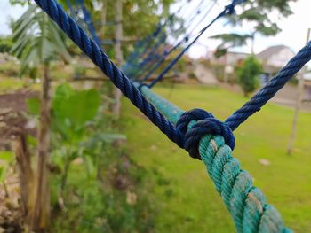 Close-up of rope tied on wooden post