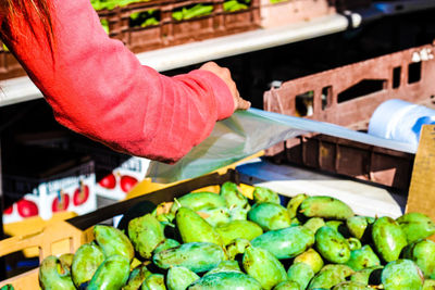 Midsection of person for sale at market stall