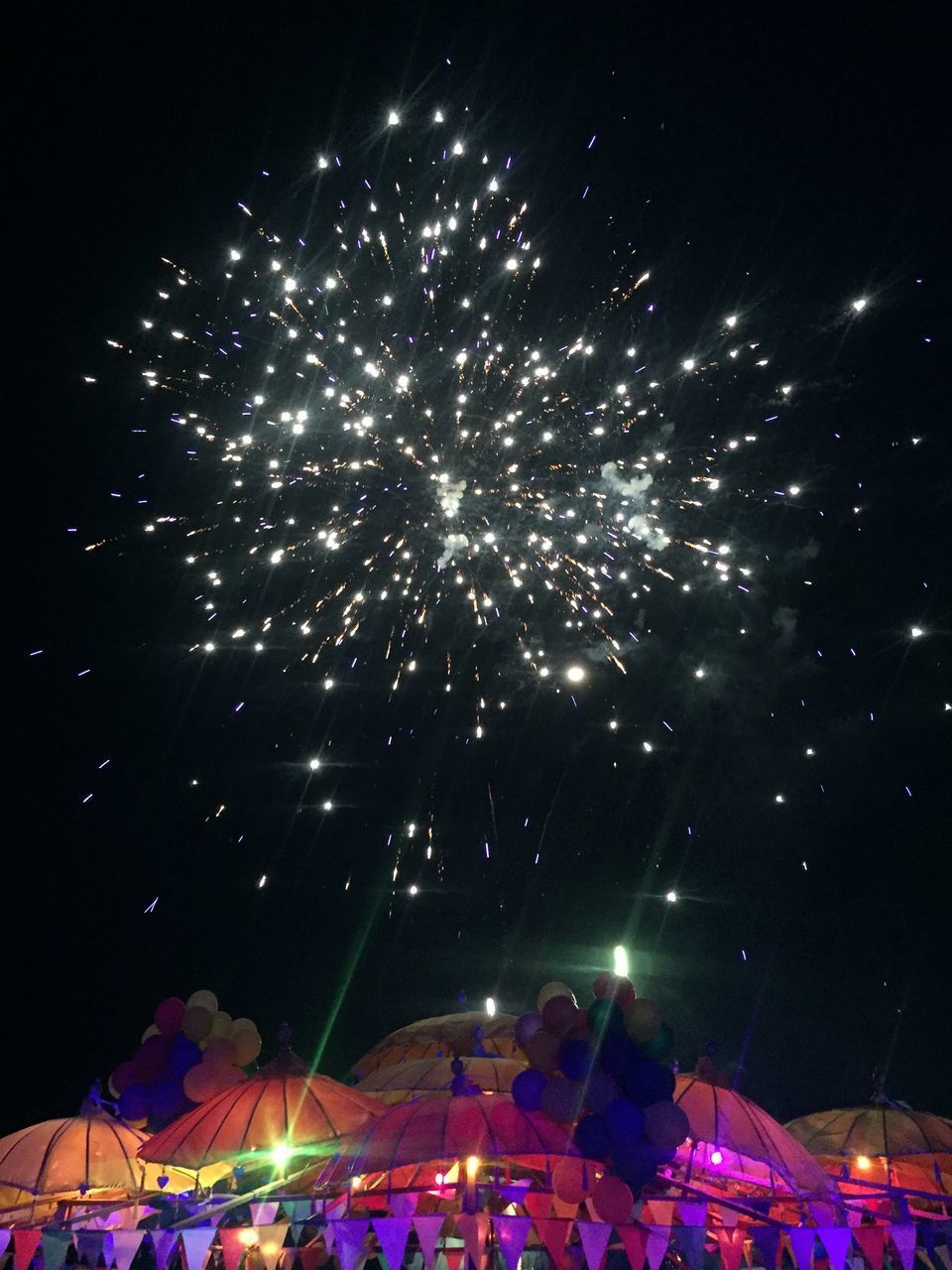 LOW ANGLE VIEW OF FIREWORKS AT NIGHT