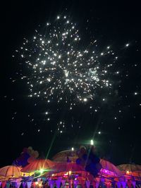 Low angle view of firework display at night