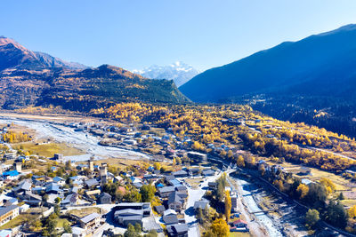 High angle view of townscape and mountains against sky