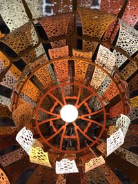 Low angle view of illuminated chandelier hanging in building