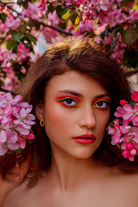 Close-up of young woman with flowers