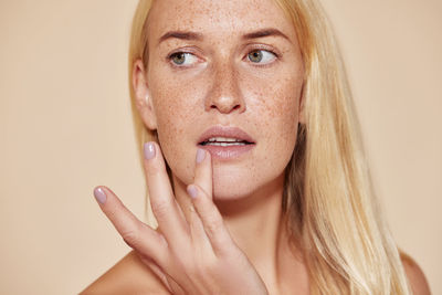 Close-up of young woman against white background