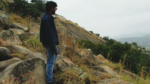 Man standing on landscape against sky