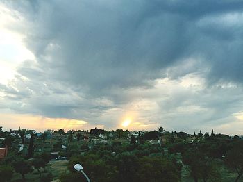 Clouds over city at sunset