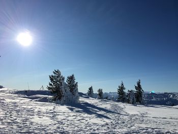 Snow covered land against clear sky