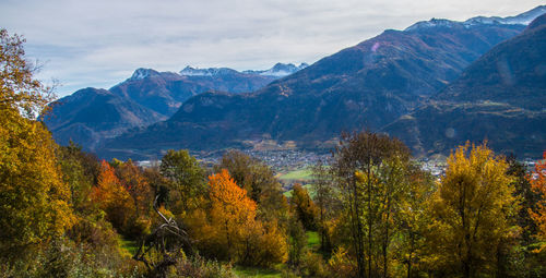 Scenic view of trees and mountains against sky during autumn