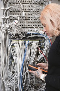 Female electrician managing cables