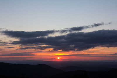 Scenic view of silhouette mountains against sky during sunset