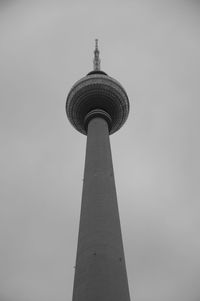 Low angle view of communications tower against sky