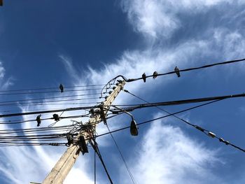 Low angle view of electricity pylon against sky