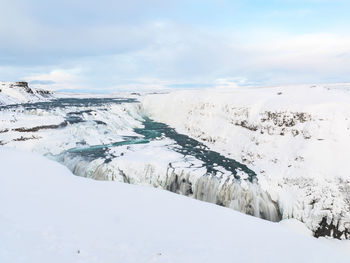 Scenic view of snow covered waterfall gulfoss, iceland