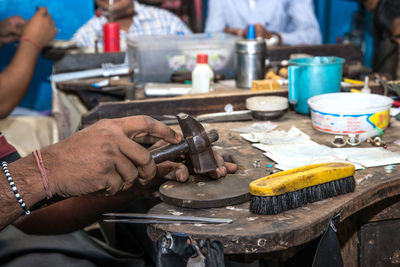 People working on metal in workshop