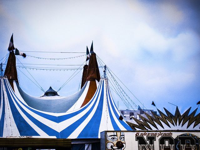 low angle view, sky, architecture, built structure, transportation, building exterior, day, mode of transport, hanging, outdoors, clear sky, nautical vessel, high section, flag, place of worship, no people, religion, roof, dome, travel