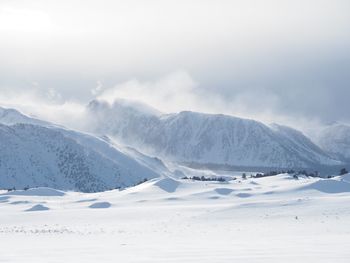 Scenic view of snow covered mountains against sky