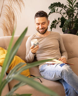 The  happy  smiling artist is sitting on the sofa . lifestyle. real emotions. lifestyle.