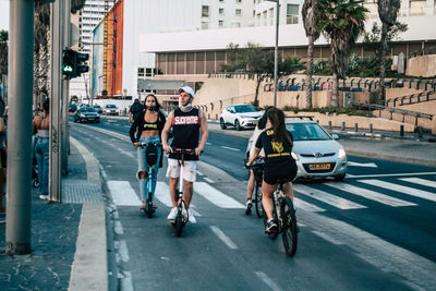 People riding bicycle on city street