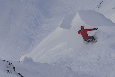 Man snowboarding on snowcapped mountain