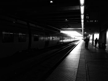 People at railroad station at night