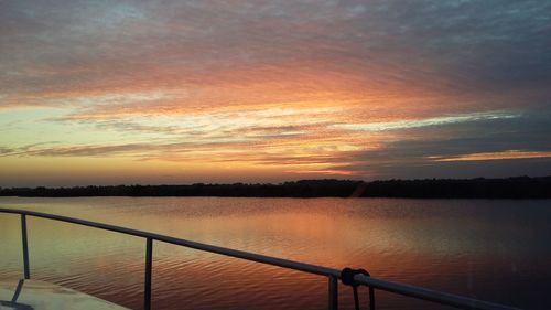 Scenic view of calm lake at sunset