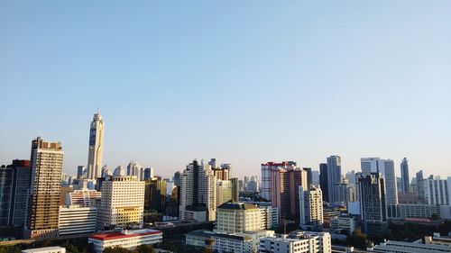 Modern buildings in city against clear sky