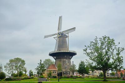 Traditional windmill against sky