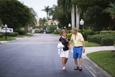 Senior couple walking hand in hand enjoying retirement