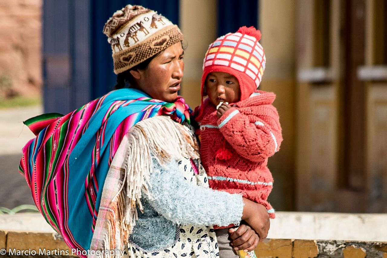 focus on foreground, lifestyles, casual clothing, front view, traditional clothing, leisure activity, person, tradition, portrait, standing, childhood, cultures, looking at camera, three quarter length, art and craft, smiling, art, creativity