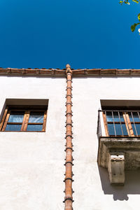 Low angle view of old building against clear blue sky