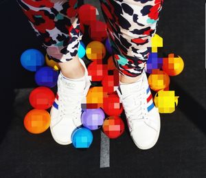 Low section of people standing on multi colored pencils