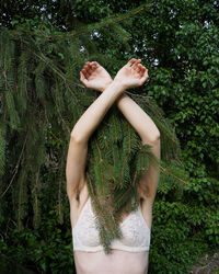 Midsection of woman standing by plants