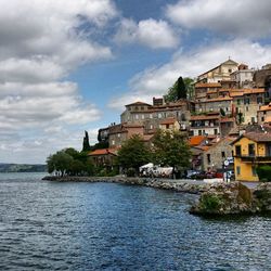 Town by sea against sky in city