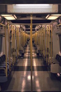 Empty narrow corridor along pillars