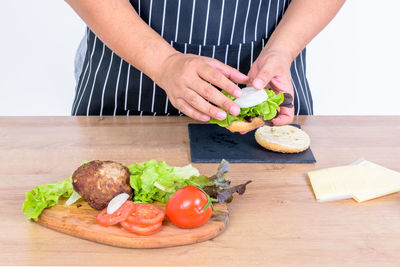 Midsection of man preparing food on cutting board