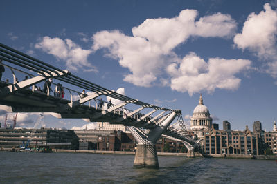 View of bridge over river against cloudy sky